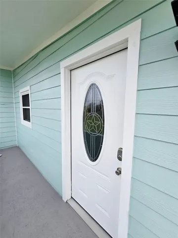 a close up of a wooden door with a wooden floor