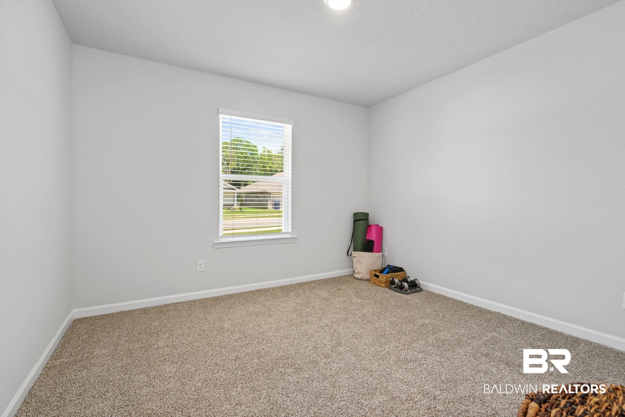8021 Valor Rdg Way North Mobile, AL 36619 - Photo 19 of 34 Neutral tone wall paint, textured ceiling, and a single window with blinds