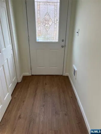 a view of hallway with wooden floor