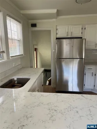 a kitchen with a refrigerator and a sink