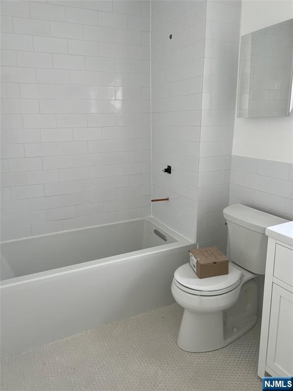 263 Sutton Avenue Hackensack, NJ 07601 - Photo 7 of 11 a white toilet sitting next to a bath tub