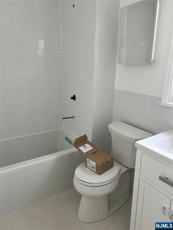 263 Sutton Avenue Hackensack, NJ 07601 - Photo 8 of 11 a white toilet and tub sitting next to a bathroom sink