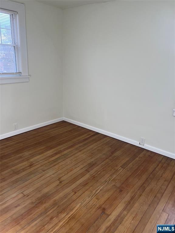 263 Sutton Avenue Hackensack, NJ 07601 - Photo 10 of 11 a view of an empty room with wooden floor and a window