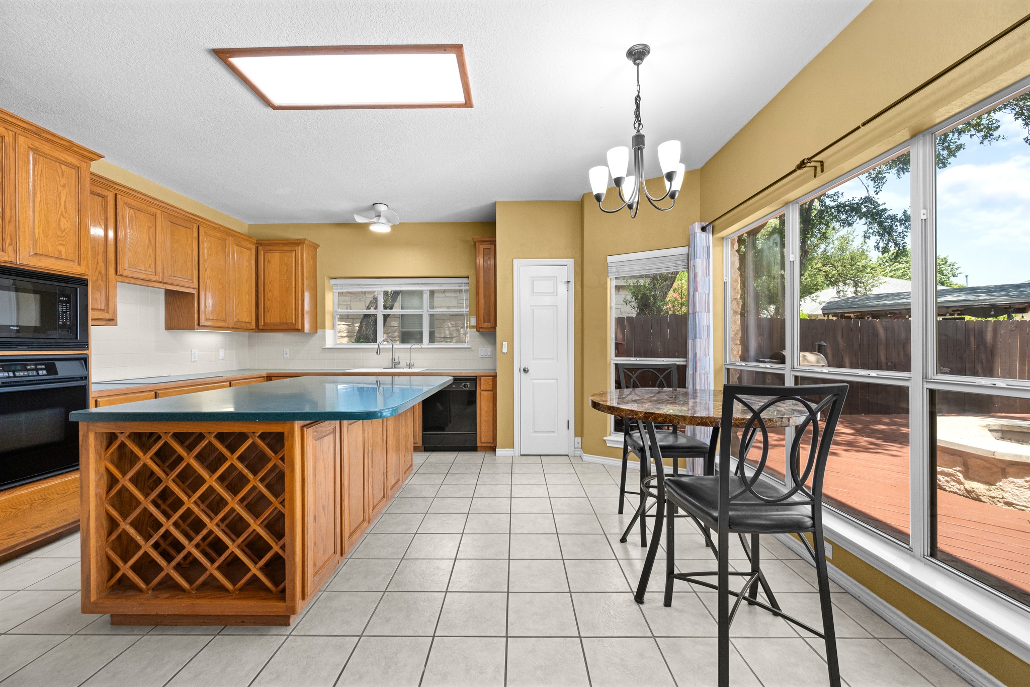 108 Thornwood Road Georgetown, TX 78628 - Photo 14 of 40 Culinary delights await in this bright kitchen with a built-in wine rack and expansive backyard views.