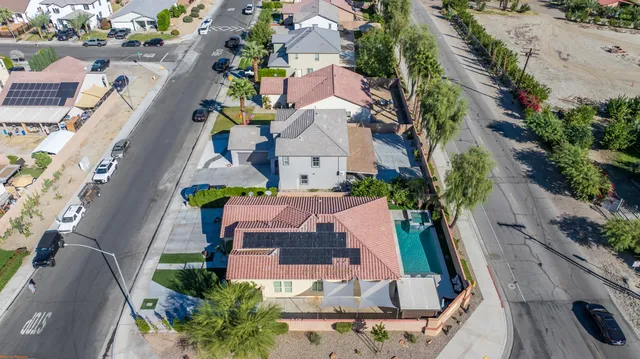 an aerial view of house with yard swimming pool and outdoor seating