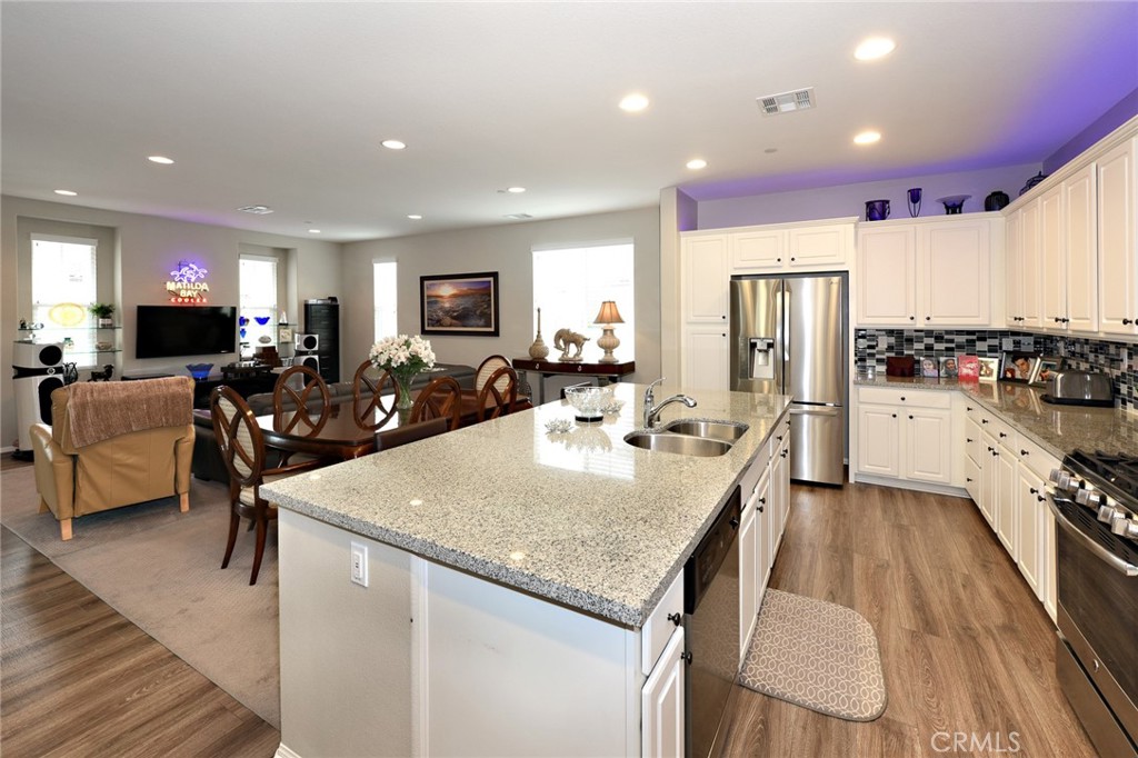 443 Stratus Lane, Unit 4 Simi Valley, CA 93065 - Photo 15 of 32 a large kitchen with sink a refrigerator and chairs