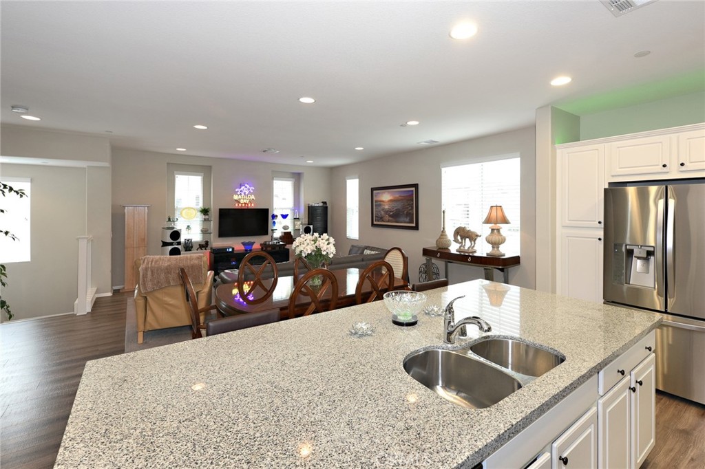 443 Stratus Lane, Unit 4 Simi Valley, CA 93065 - Photo 16 of 32 a kitchen with sink a refrigerator and chairs