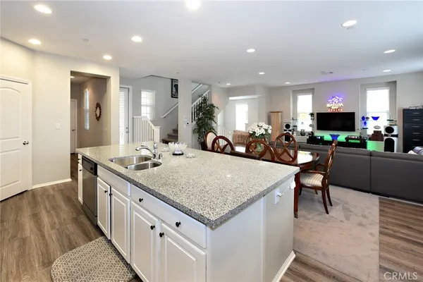 a kitchen with stainless steel appliances granite countertop a kitchen island a stove and a sink