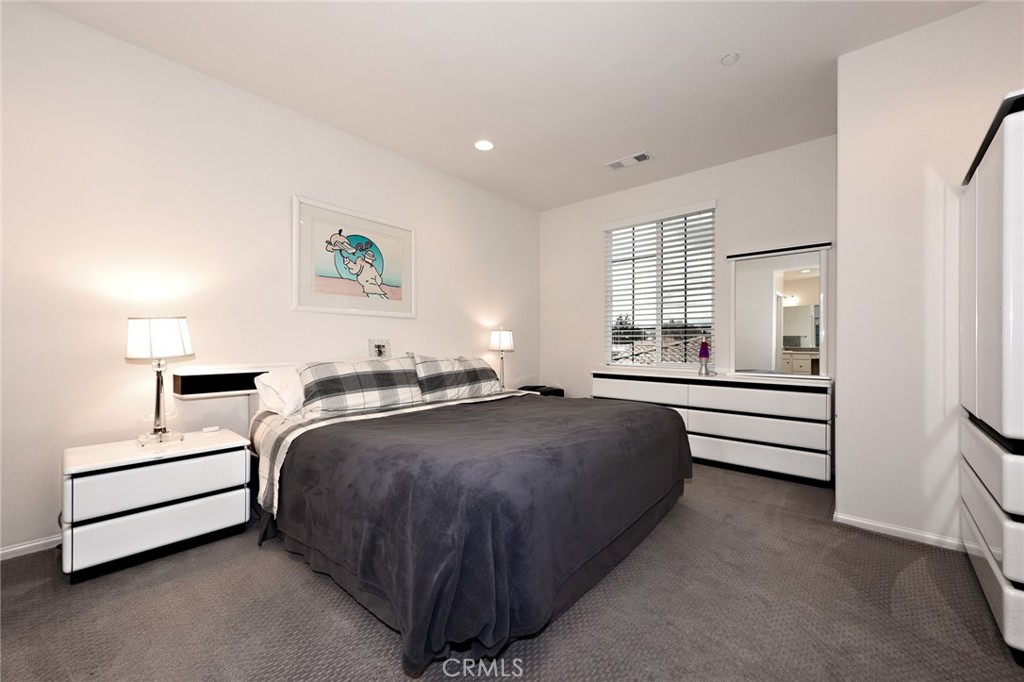 443 Stratus Lane, Unit 4 Simi Valley, CA 93065 - Photo 19 of 32 a bedroom with a bed and a night stand