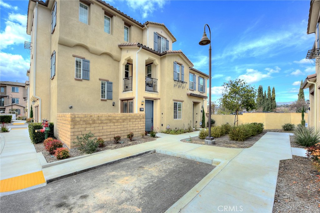 443 Stratus Lane, Unit 4 Simi Valley, CA 93065 - Photo 2 of 32 a view of a white house with a large windows and a yard