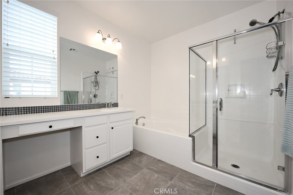 443 Stratus Lane, Unit 4 Simi Valley, CA 93065 - Photo 22 of 32 a spacious bathroom with a double vanity sink a large mirror and shower