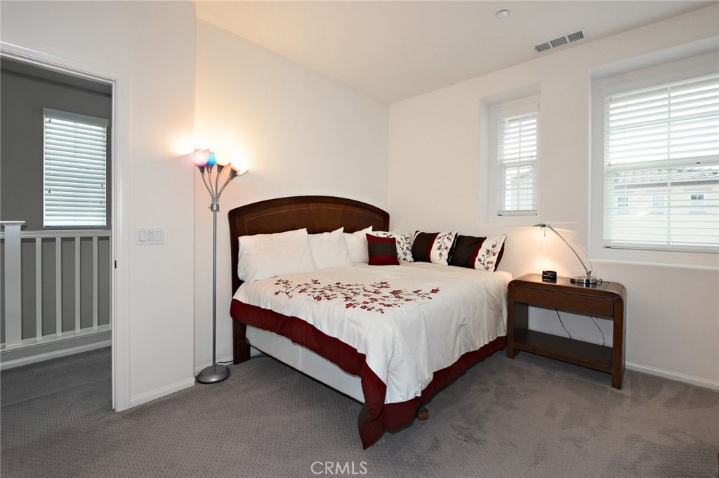 443 Stratus Lane, Unit 4 Simi Valley, CA 93065 - Photo 25 of 32 a bedroom with a bed lamp closet and window