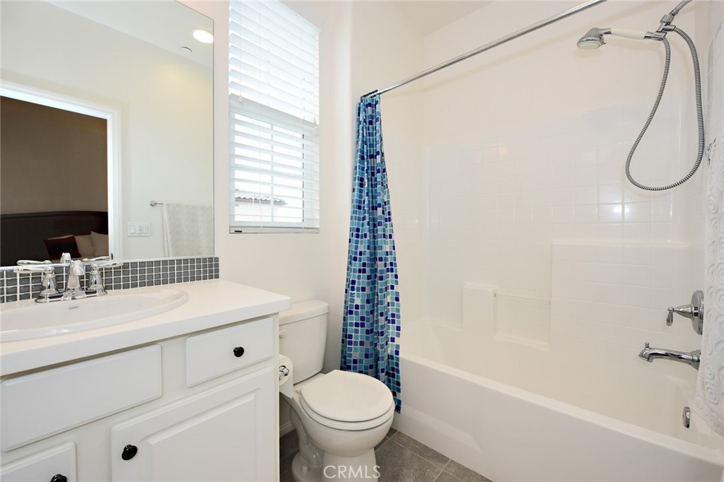 443 Stratus Lane, Unit 4 Simi Valley, CA 93065 - Photo 26 of 32 a bathroom with a granite countertop sink a toilet and a mirror