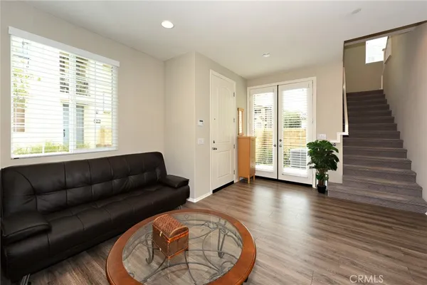 a living room with furniture and a wooden floor