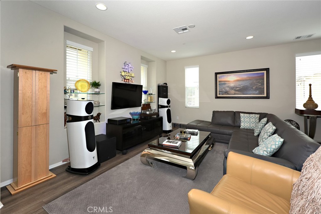 443 Stratus Lane, Unit 4 Simi Valley, CA 93065 - Photo 10 of 32 a living room with furniture a flat screen tv and a window