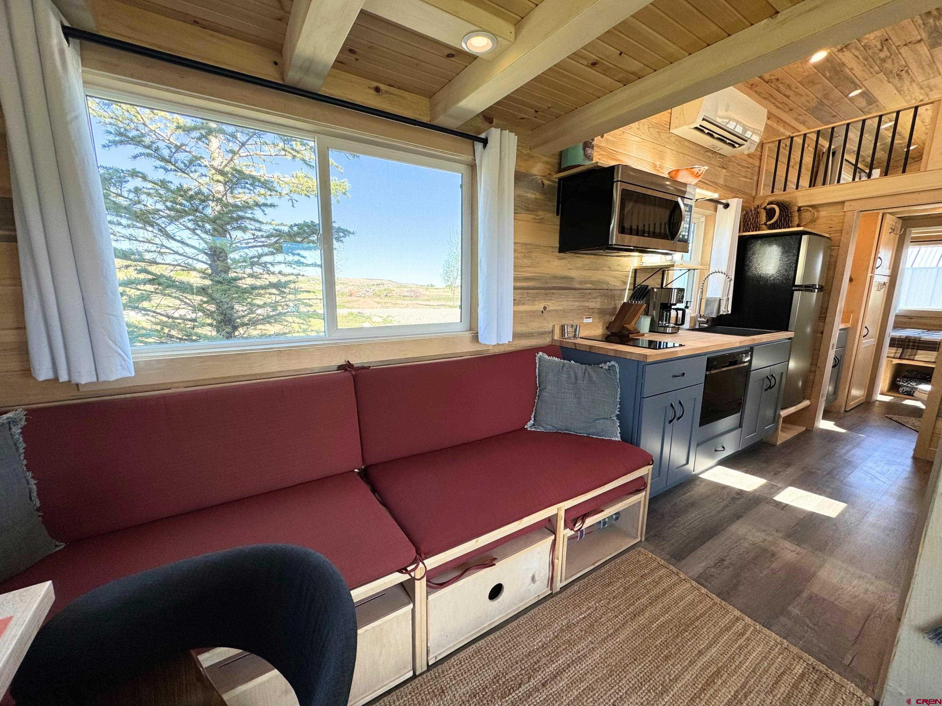 22130 6850 Road, Unit 211 Montrose, CO 81403 - Photo 11 of 25 a room with furniture and a flat screen tv