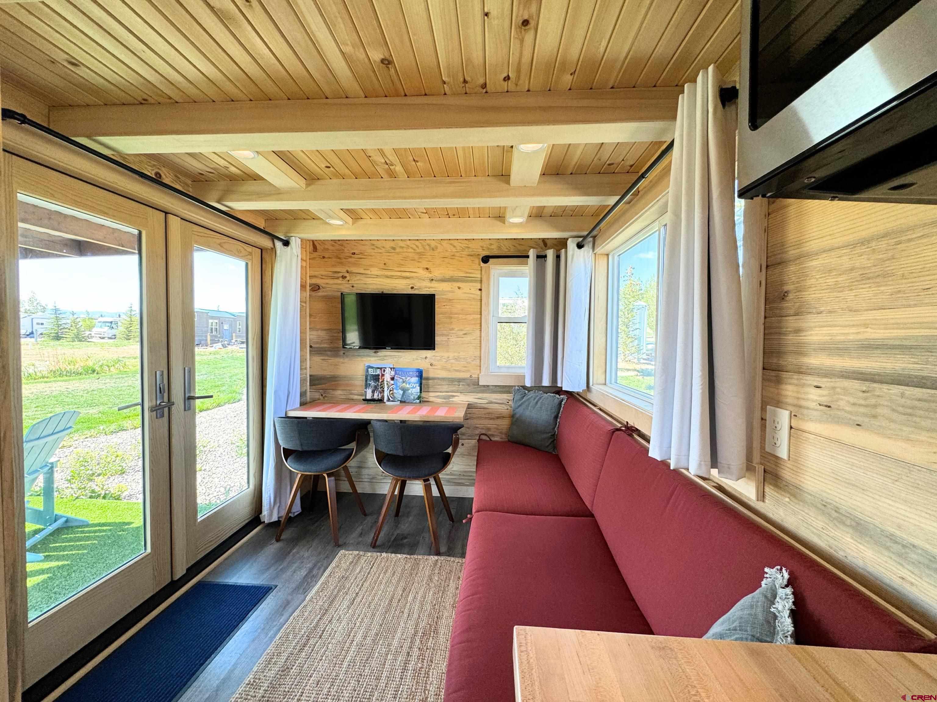 22130 6850 Road, Unit 211 Montrose, CO 81403 - Photo 12 of 25 a living room with furniture and a large window