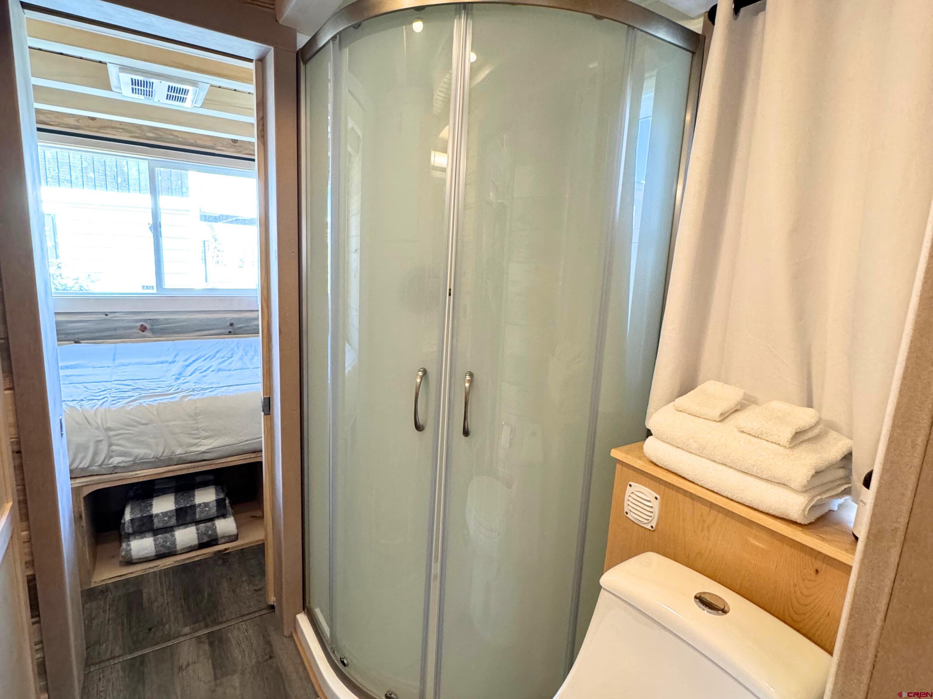 22130 6850 Road, Unit 211 Montrose, CO 81403 - Photo 14 of 25 a bathroom with a sink toilet and window