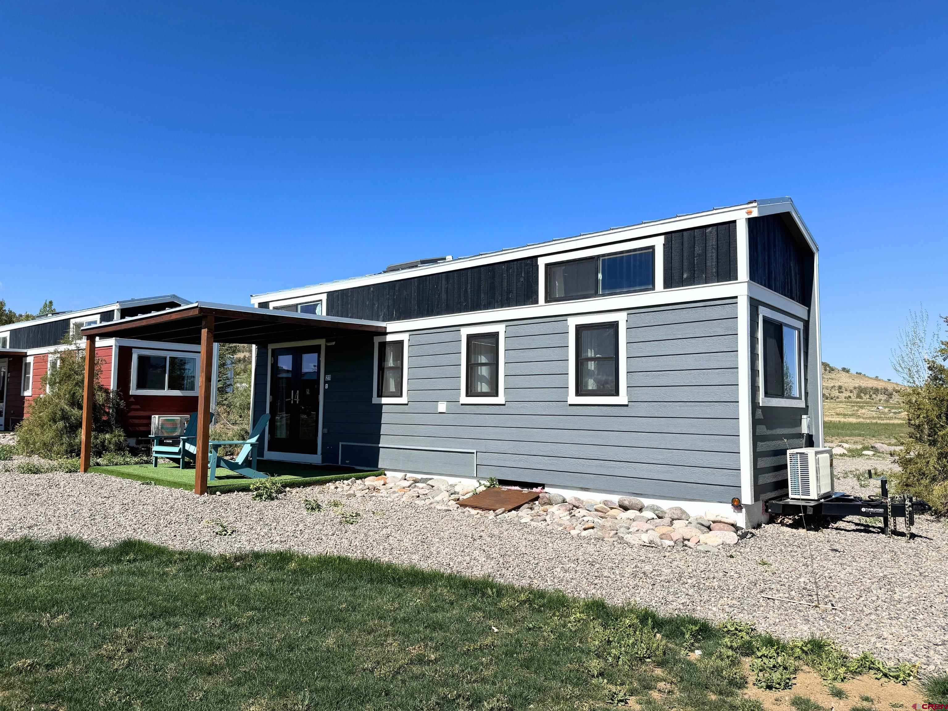 22130 6850 Road, Unit 211 Montrose, CO 81403 - Photo 18 of 25 a front view of a house with a yard