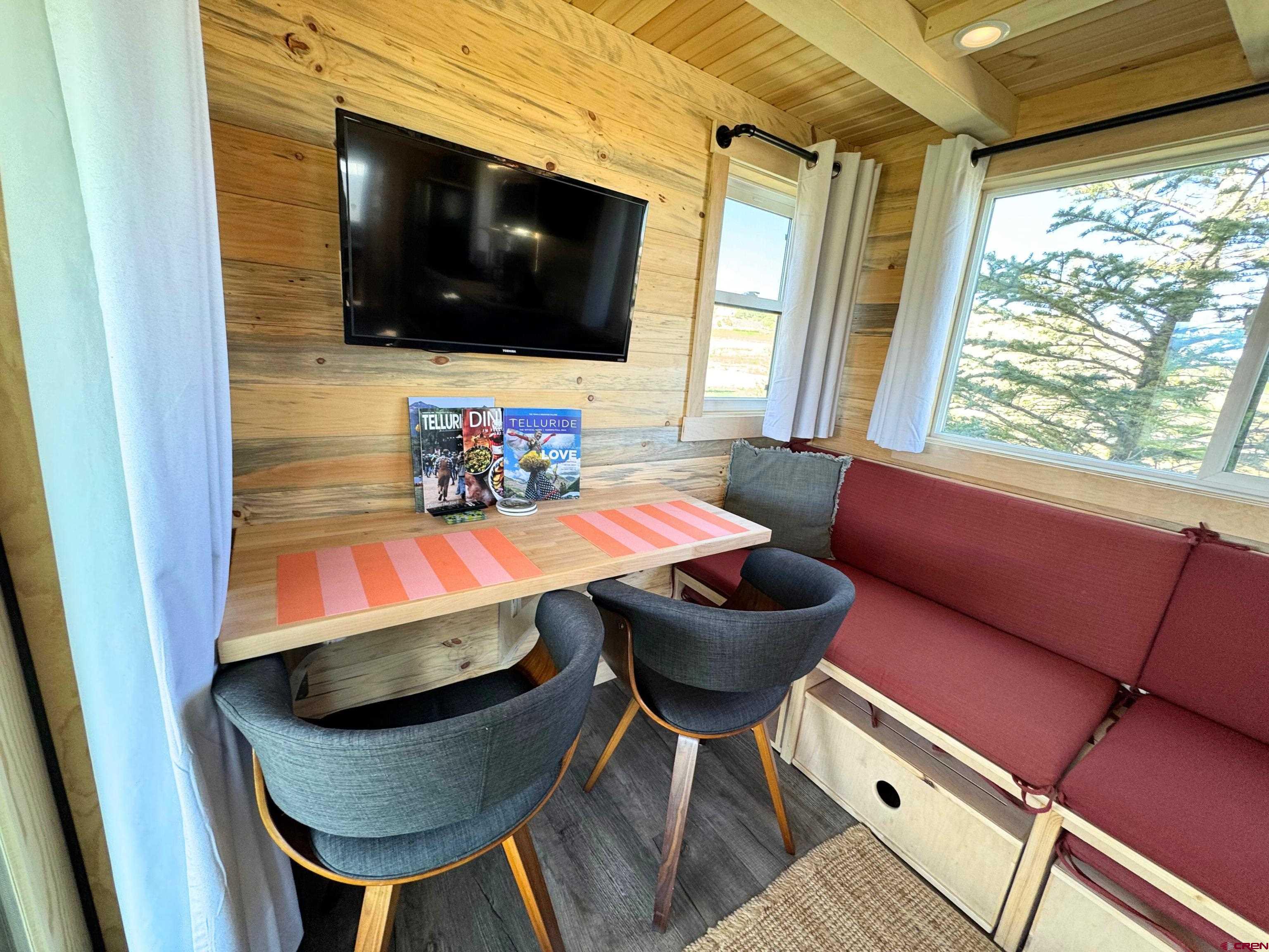 22130 6850 Road, Unit 211 Montrose, CO 81403 - Photo 5 of 25 a living room with furniture and a flat screen tv