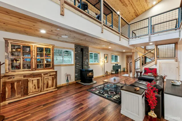 a living room with furniture stove and wooden floor