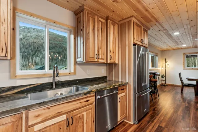 a kitchen with stainless steel appliances a sink and cabinets