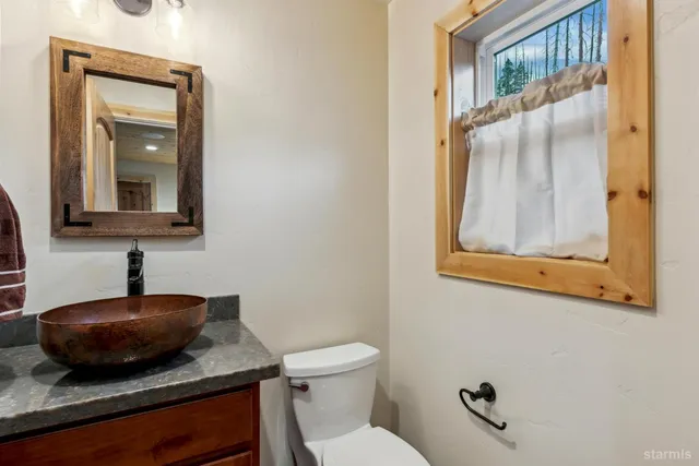 a bathroom with a toilet sink and mirror