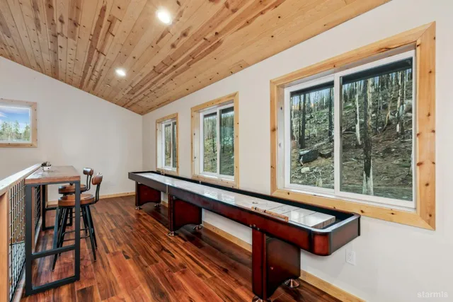 a view of a room with furniture wooden floor and windows