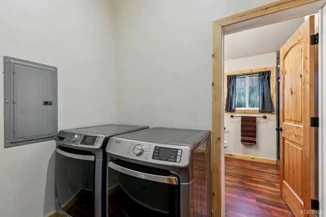 a view of washer and dryer with wooden floor