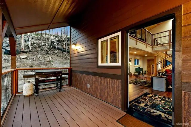 a area with wooden floor and outdoor seating