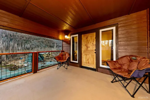 a balcony with furniture and a gate
