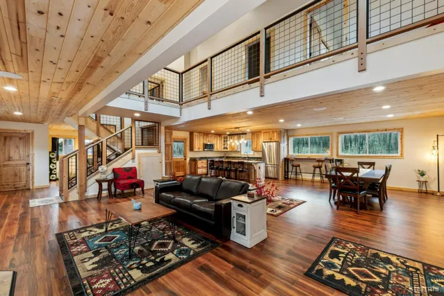 a living room with lots of furniture wooden floor and rug