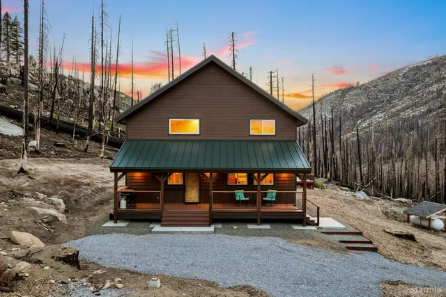 a view of house with outdoor space and sitting area