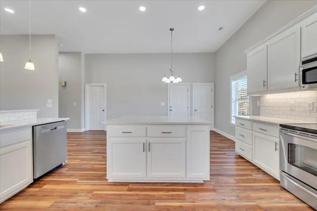 a spacious bathroom with a granite countertop sink a mirror and a