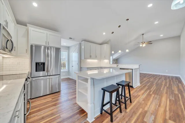 a bathroom with bathtub next to a window
