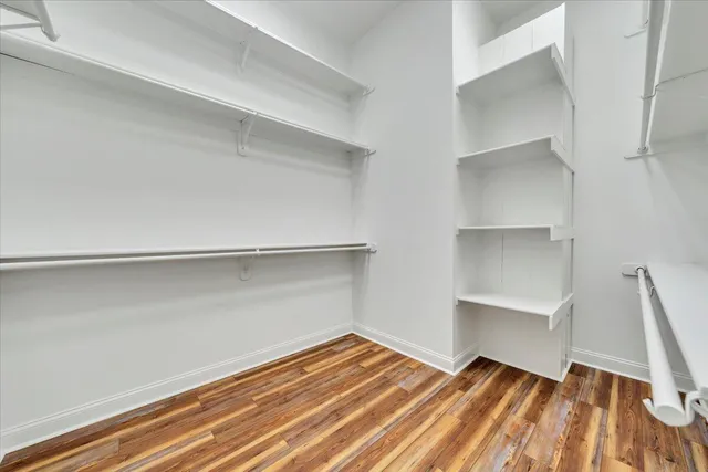 a view of a hallway with wooden shelves