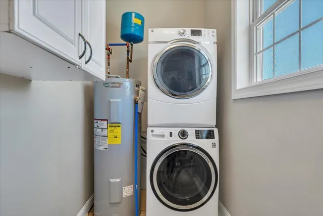 a backyard of a house with large trees and wooden fence