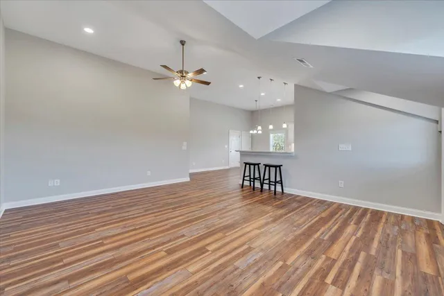 a kitchen with kitchen island wooden floors and stainless steel appliances