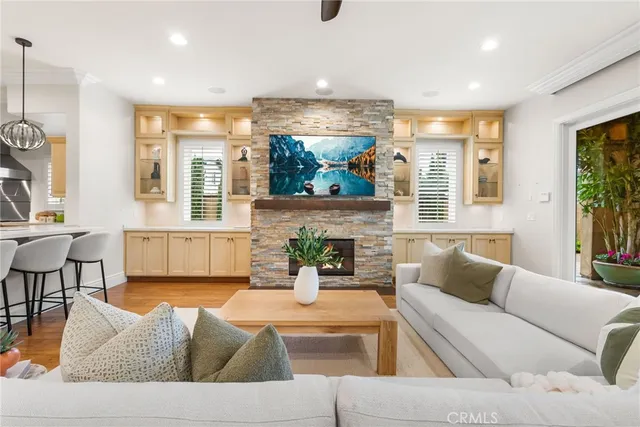 a living room with furniture wooden floor and a fireplace
