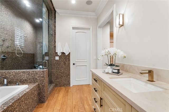 a bathroom with a tub sink and mirror
