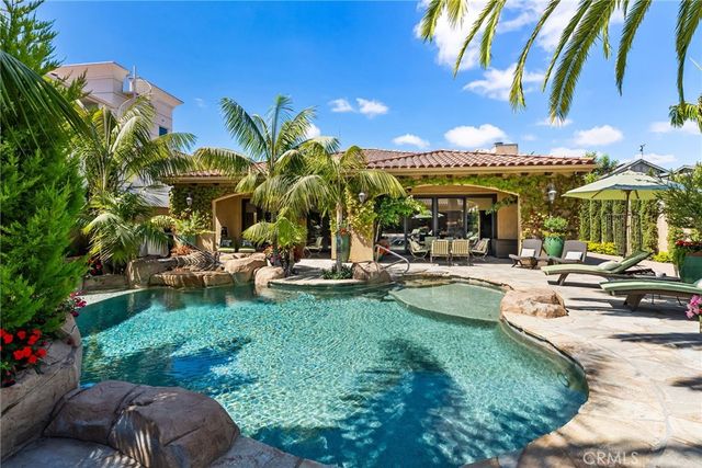 a view of a backyard with plants and swimming pool