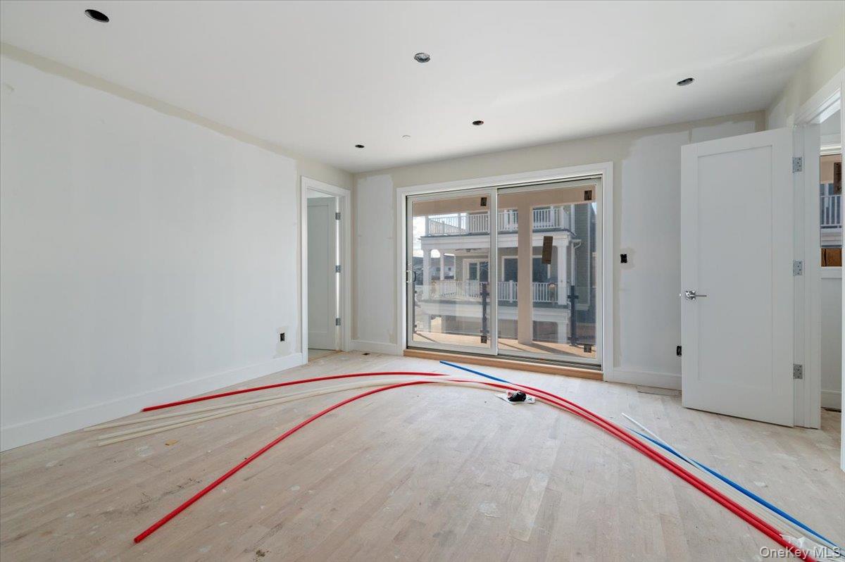 56 Oregon Street Long Beach, NY 11561 - Photo 12 of 25 Spare room with wood finished floors and recessed lighting