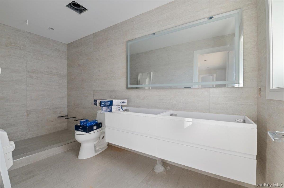56 Oregon Street Long Beach, NY 11561 - Photo 13 of 25 Bathroom featuring tile walls and vanity