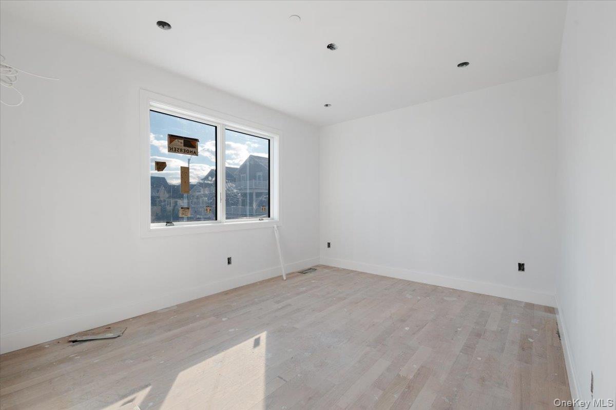 56 Oregon Street Long Beach, NY 11561 - Photo 14 of 25 Unfurnished room with light wood-type flooring and baseboards
