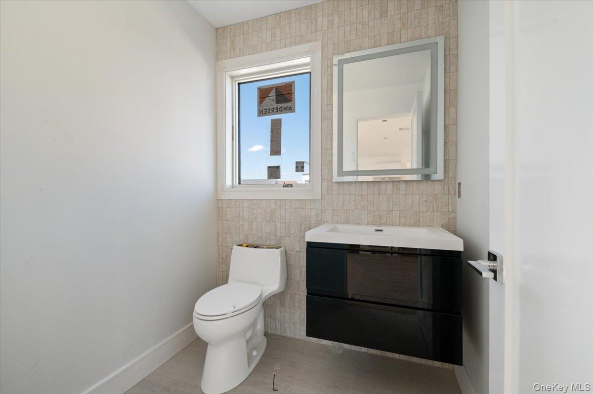 56 Oregon Street Long Beach, NY 11561 - Photo 6 of 25 Bathroom with vanity, tile walls, and tile patterned flooring