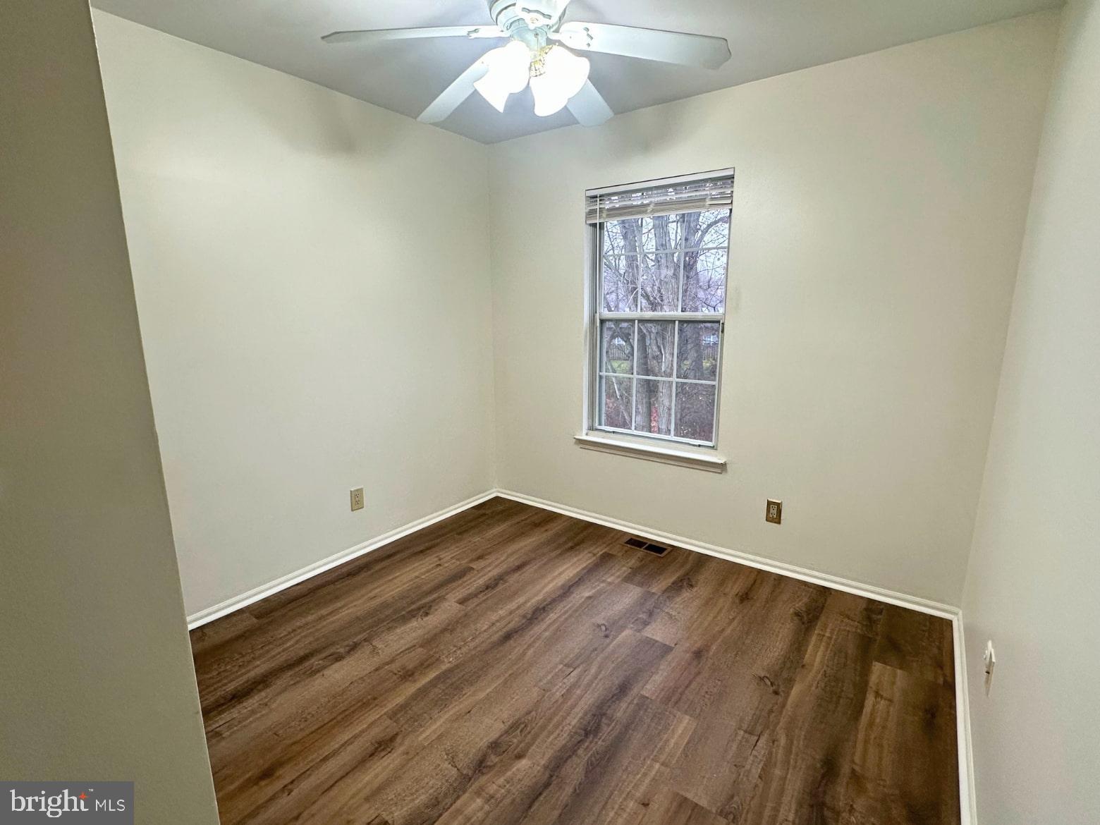 329 Gwynedd Court Mount Laurel, NJ 08054 - Photo 13 of 15 an empty room with wooden floor chandelier and window