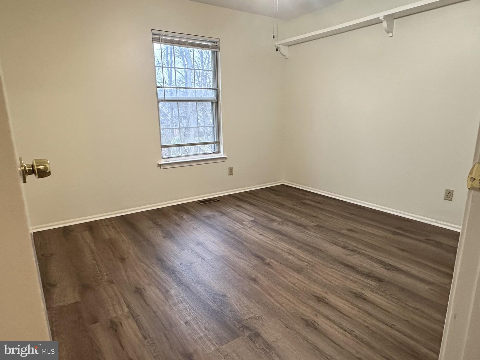 329 Gwynedd Court Mount Laurel, NJ 08054 - Photo 14 of 15 a view of an empty room with wooden floor and a window
