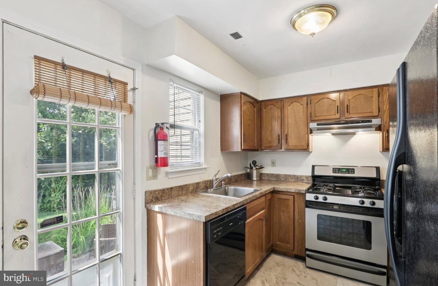 329 Gwynedd Court Mount Laurel, NJ 08054 - Photo 8 of 15 a kitchen with a sink stove and refrigerator