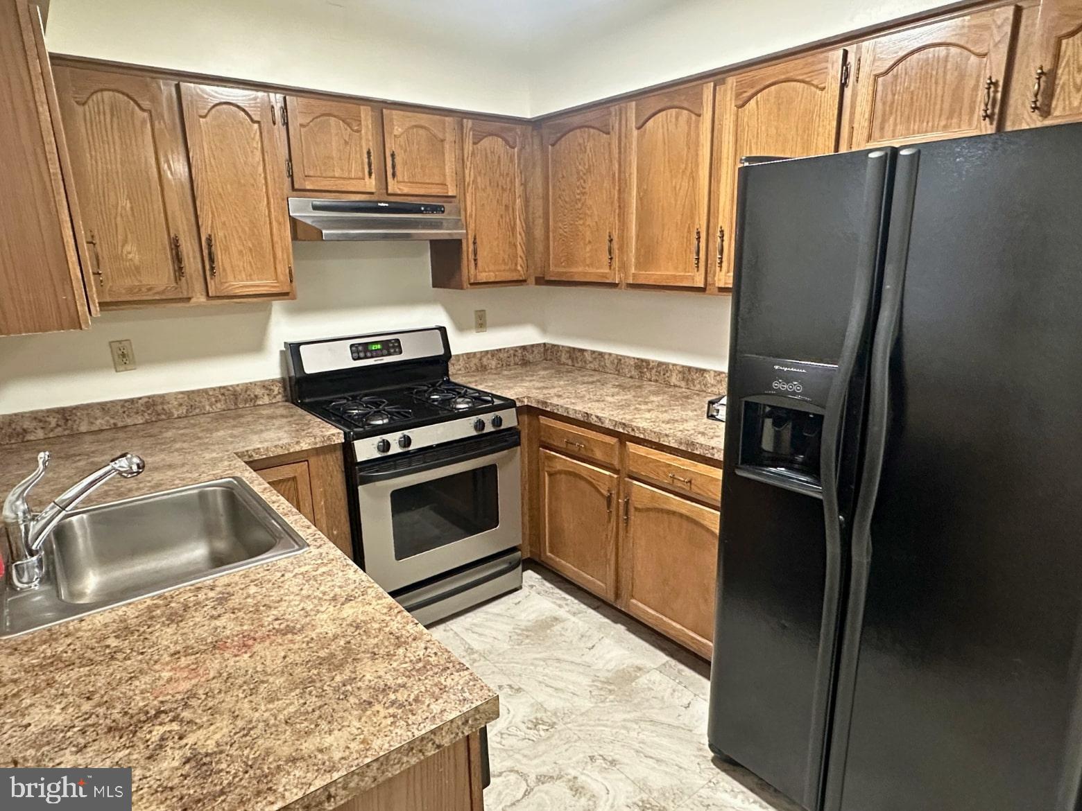 329 Gwynedd Court Mount Laurel, NJ 08054 - Photo 9 of 15 a kitchen with granite countertop a refrigerator stove and sink