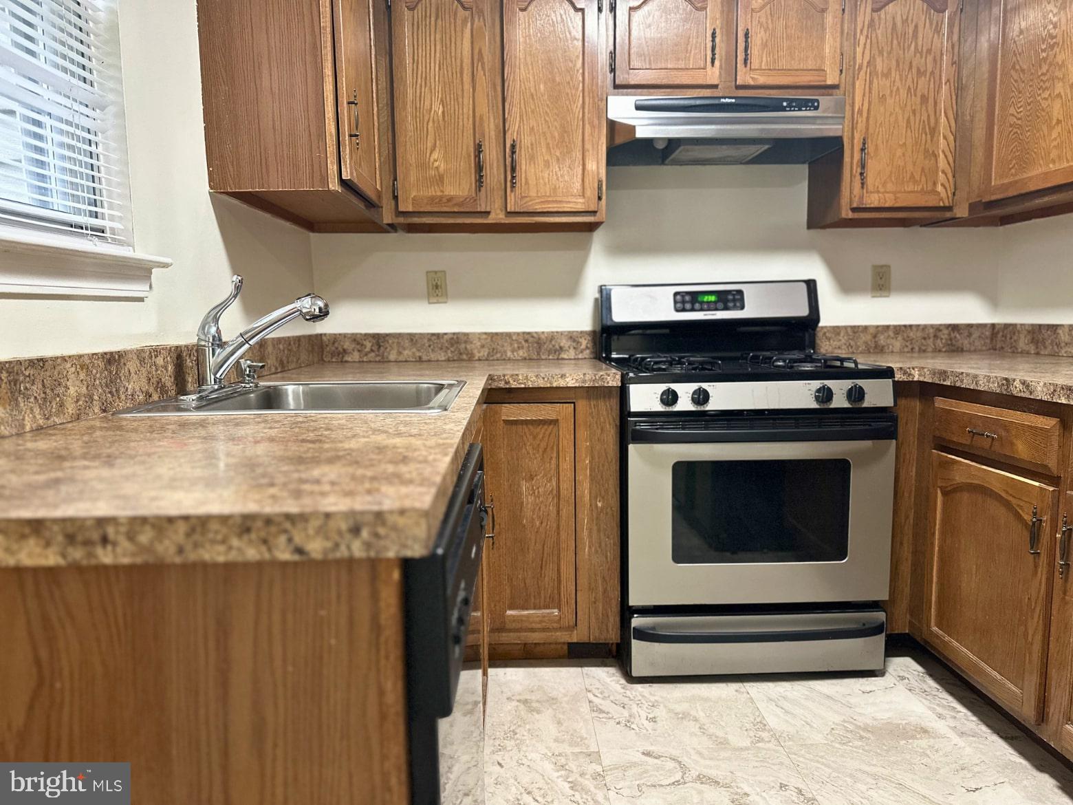 329 Gwynedd Court Mount Laurel, NJ 08054 - Photo 10 of 15 a kitchen with granite countertop a stove and a sink